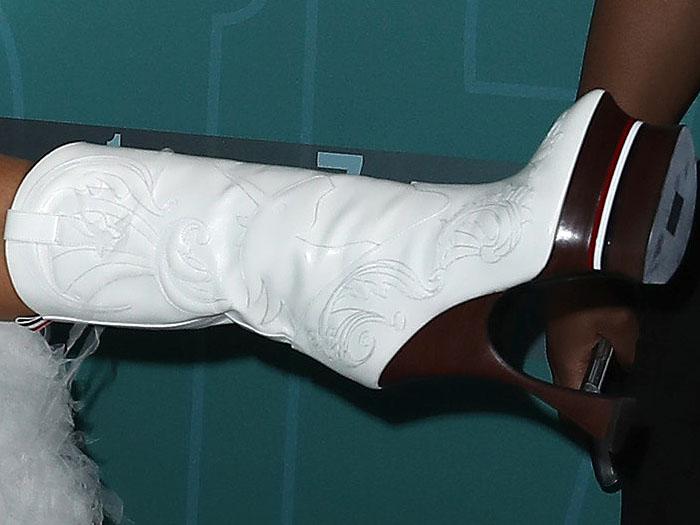 Erykah Badu's white platform cowboy boots with wooden gun heels