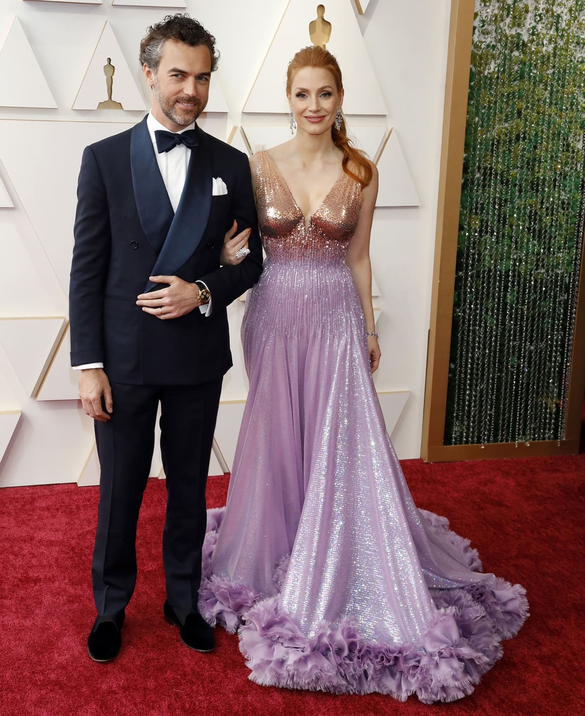 Gian Luca Passi de Preposulo and Jessica Chastain in a pink and gold Gucci ensemble attend the 94th Annual Academy Awards