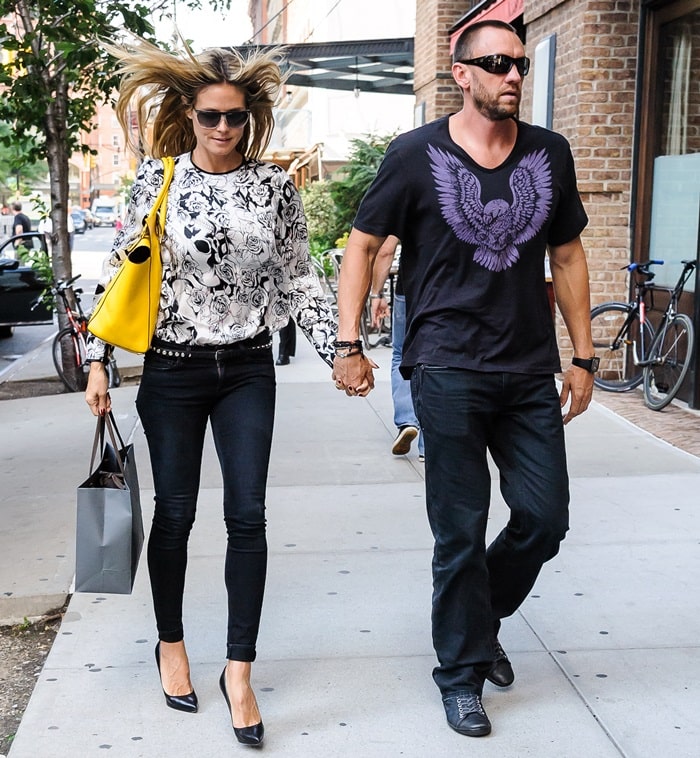 Heidi Klum steps out in classic black heels and skinny jeans, adding a pop of color with her yellow Michael Kors tote, while Martin Kristen keeps it cool in a graphic tee and sneakers during their Soho shopping date on June 11, 2013