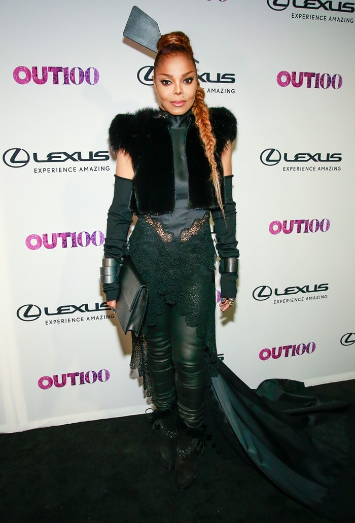 Janet Jackson made a bold statement in a dramatic David Ferreira outfit featuring leather-look pants, a lace-accented train, fur vest, and towering boots