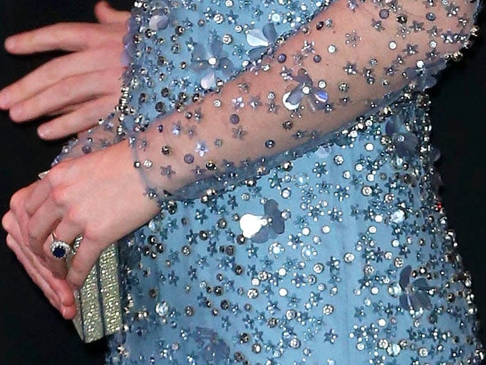 Details of Kate Middleton's Jenny Packham miniature 'Casa' clutch and bespoke blue Jenny Packham long-sleeved gown with a sheer overlay covered in crystal and flower embellishments.