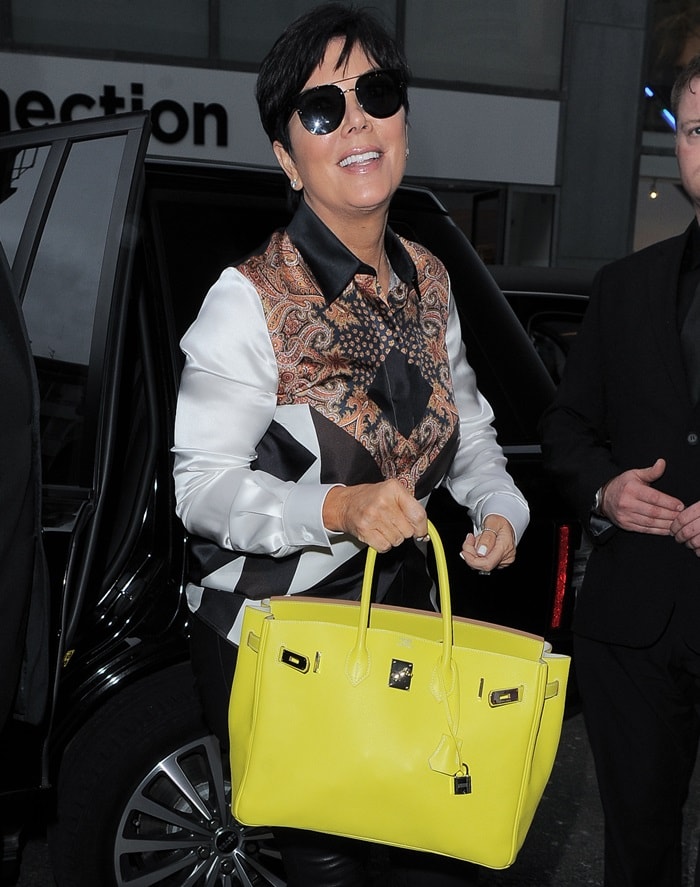 A pop of color in high fashion: Kris Jenner accentuates her sophisticated ensemble with a striking yellow Hermès Birkin, the epitome of luxury