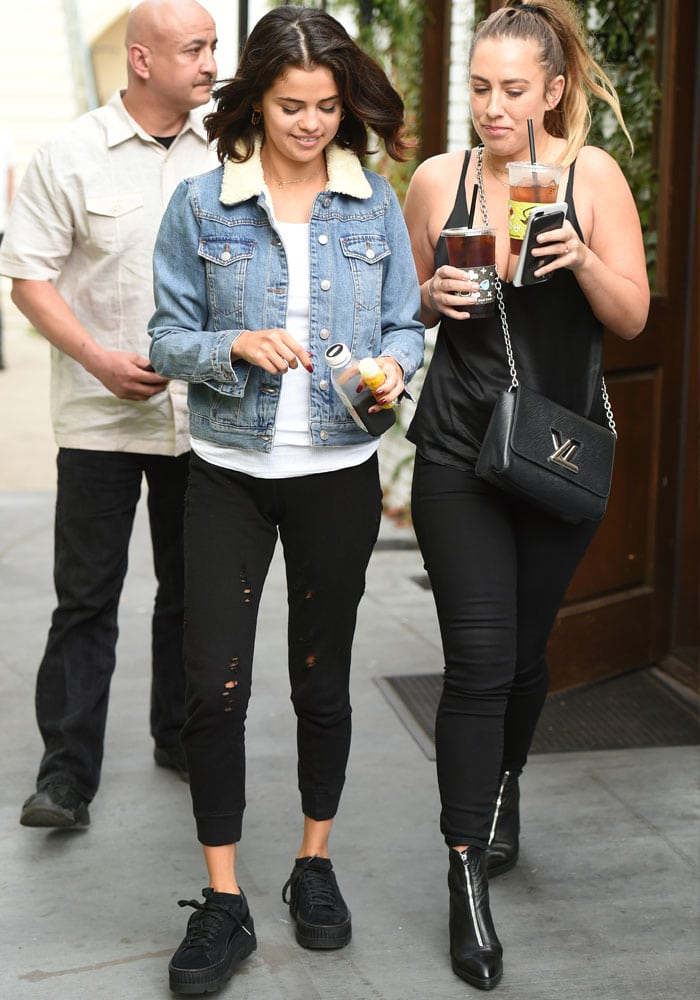 Selena Gomez emerges from the coffee shop with a friend