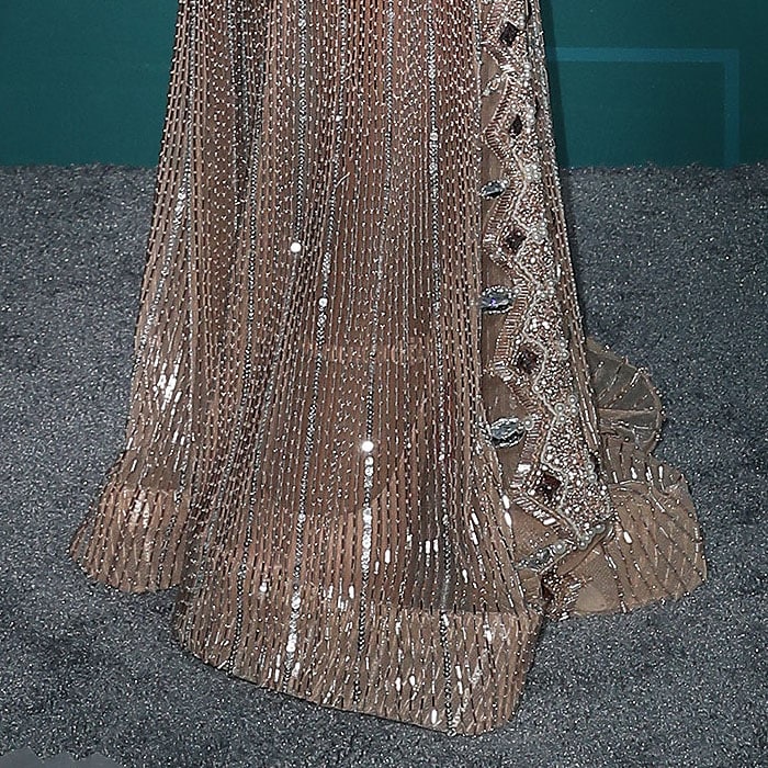 Closeup of Toni Braxton's nude platform mary-jane pumps peeking out from the hem of her sheer dress