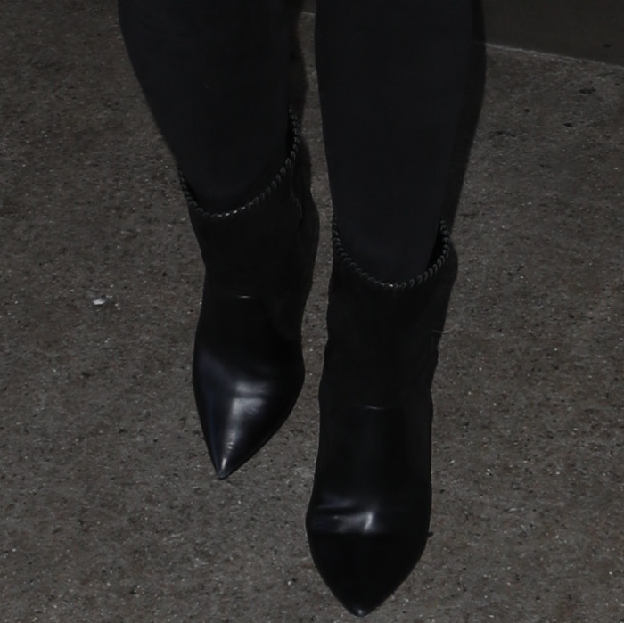 Chrissy Teigen wears jeans with mixed leather mid-calf boots