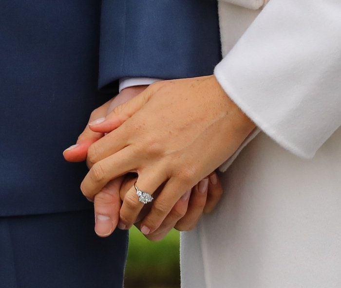 Meghan Markle's engagement ring, designed by Prince Harry and crafted by Cleave & Company, features a cushion-cut diamond from Botswana flanked by two stones from Princess Diana’s collection—an elegant, deeply personal trilogy