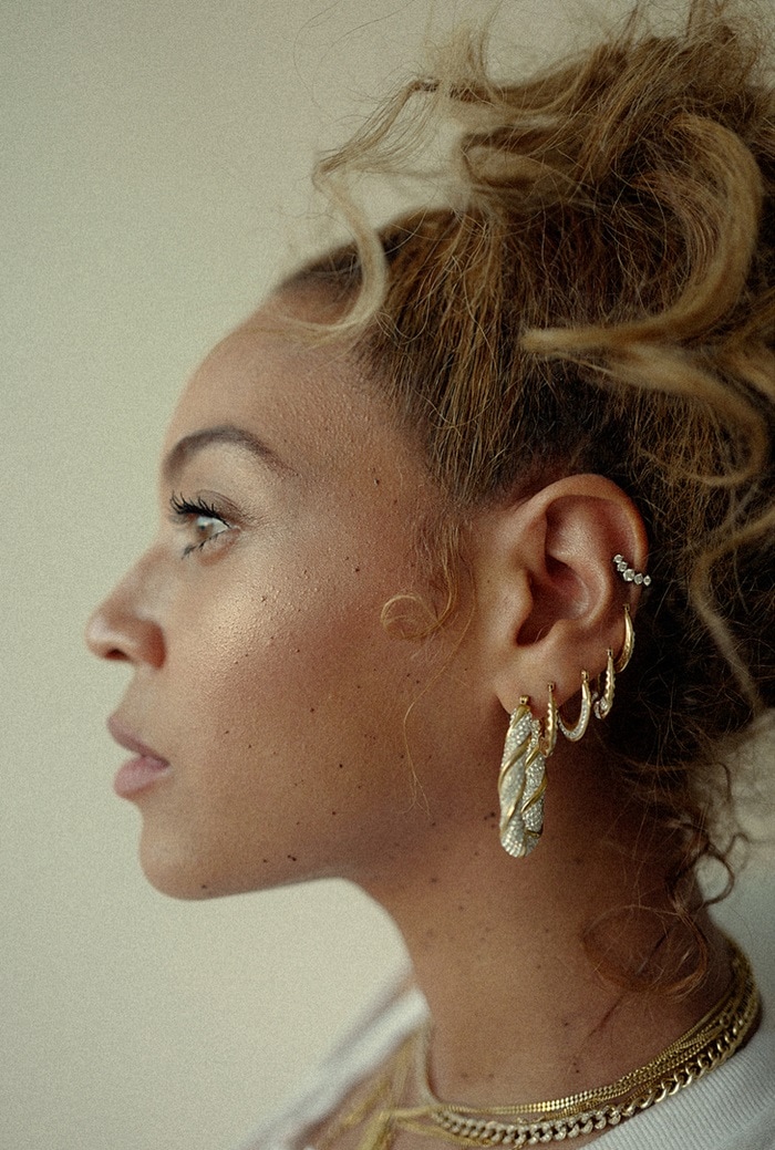 Beyonce showing off her hoop earrings and signature blond locks