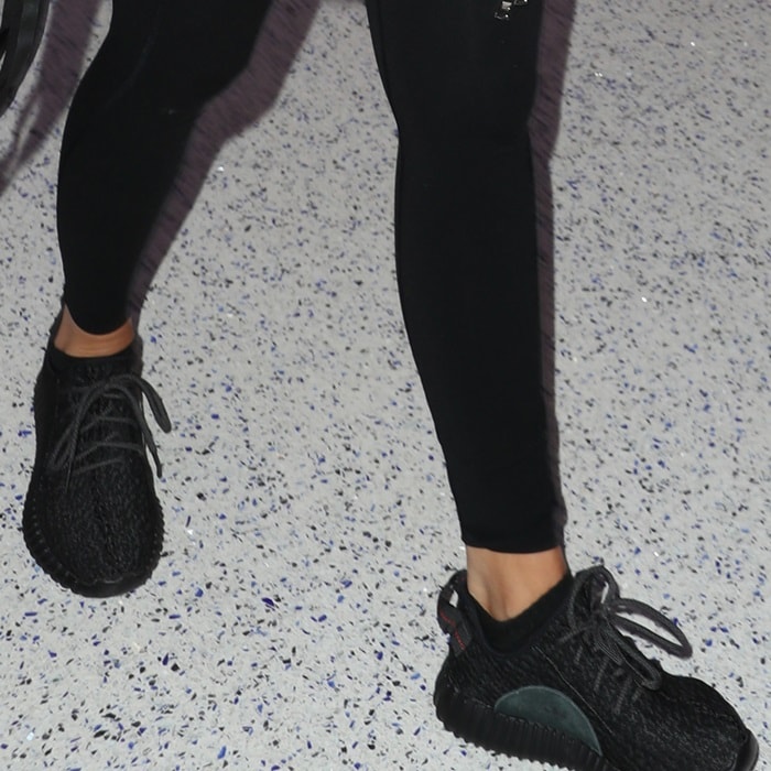 Khloe Kardashian wearing Adidas x Kanye West Yeezy Boost 350 sneakers in black pirate