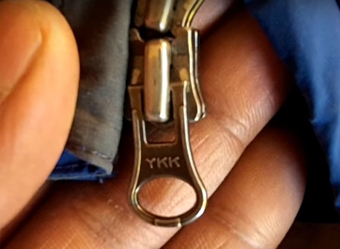 Close-up of a YKK zipper on a The North Face jacket, a key detail in verifying authenticity