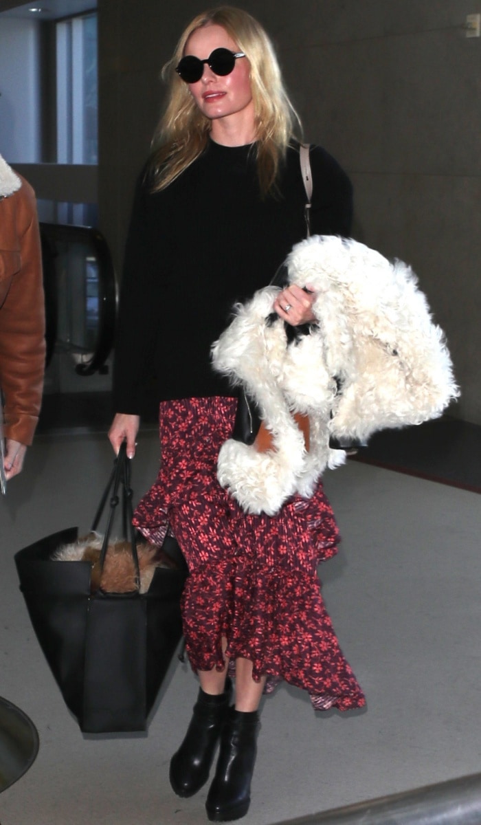 Kate Bosworth wearing a Naked Cashmere "Campbell" sweater, an Ulla Johnson "Maria" ruffled printed maxi skirt, and Nicholas Kirkwood "Annabel" boots at LAX