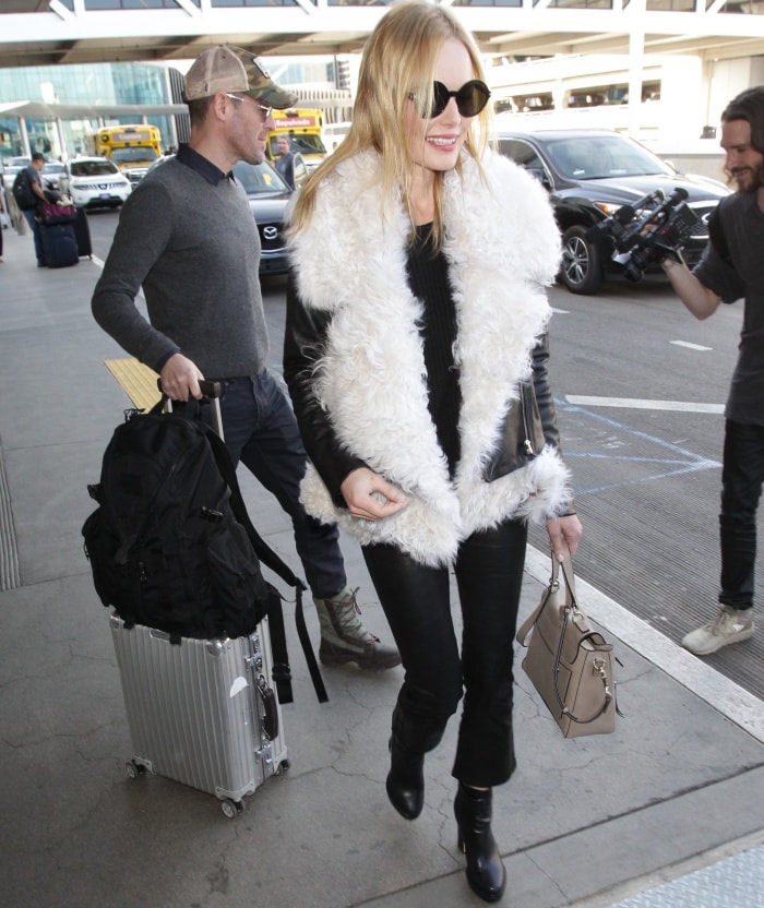 Kate Bosworth wearing a black leather jacket, J Brand "Maria" leather pants, and Nichols Kirkwood "Annabel" boots at LAX