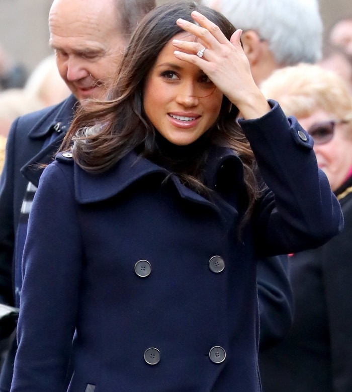 Meghan Markle shows off her gold and diamond trilogy engagement ring