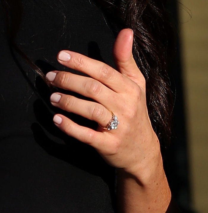 Meghan Markle's Cleave & Company engagement ring features a cushion diamond and a pair of round side stones on a gold band