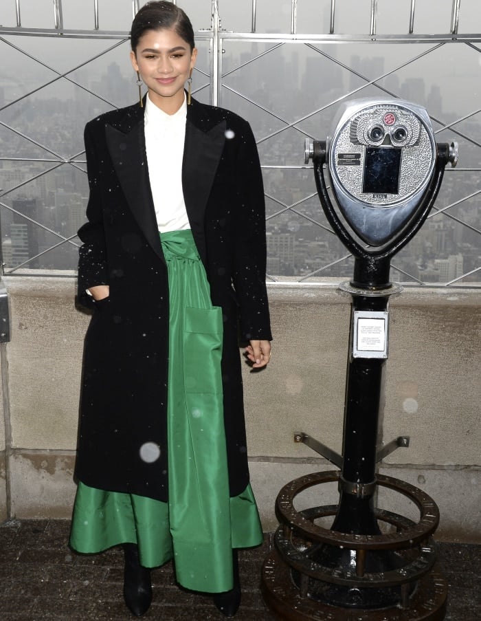 Zendaya styled her black Ralph Lauren double-breasted coat with a green Martin Grant skirt