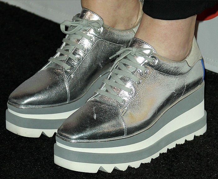 Details of Amy Poehler's Stella McCartney 'Sneak-Elyse' rubber-platform trainers in silver metallic.