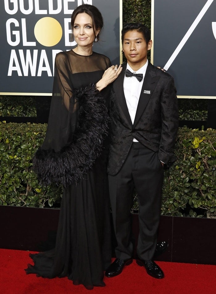 Angelina Jolie posed for photos with her son Pax Jolie-Pitt, 14, while walking the red carpet at the 2018 Golden Globe Awards held at the Beverly Hilton Hotel
