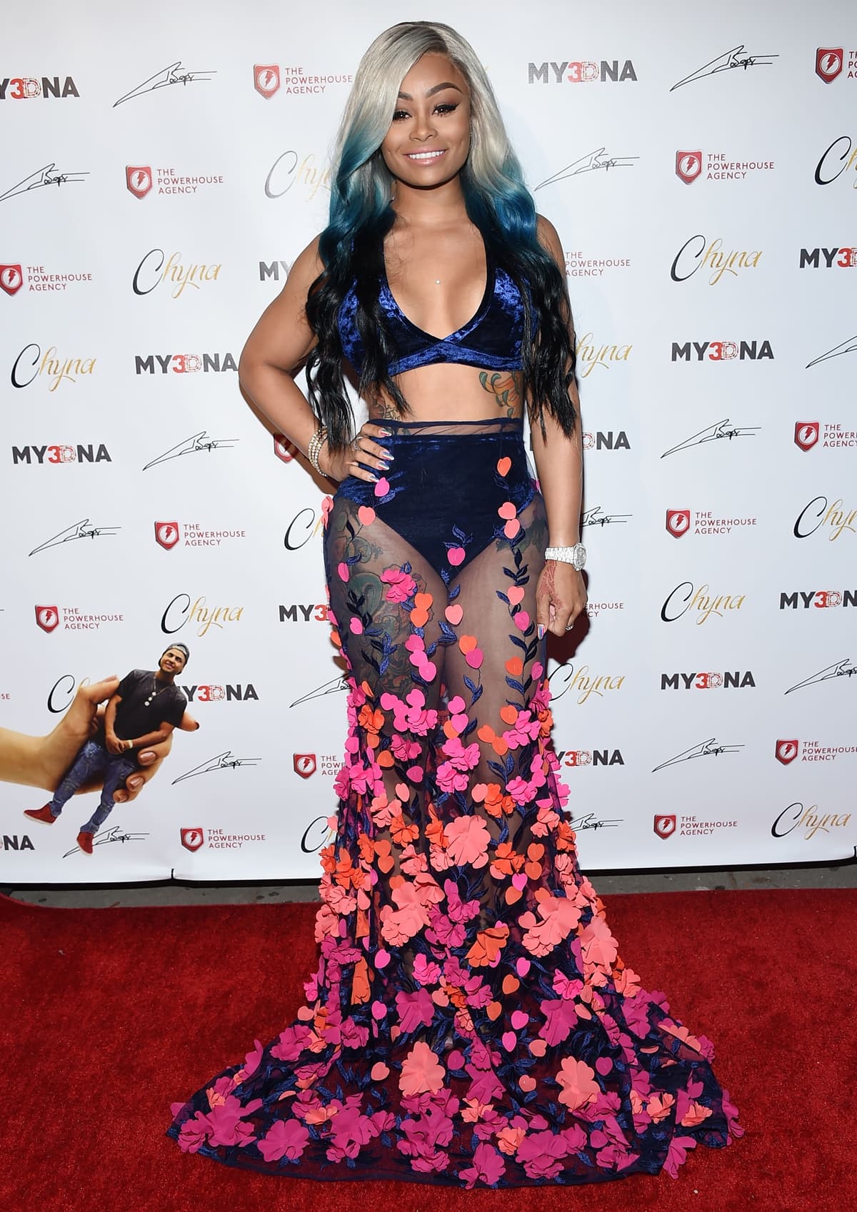 Blac Chyna in a c custom crushed velvet and 3D Floral dress by Shane Justin at the Blac Chyna Figurine Doll Launch