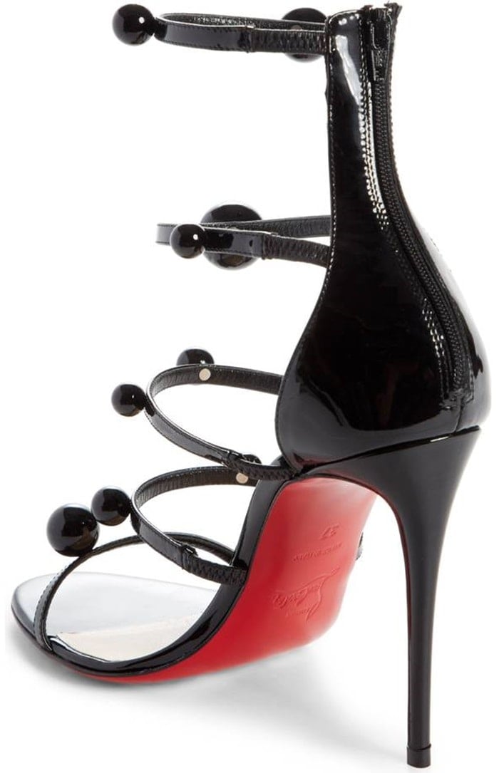 Christian Louboutin's iconic red sole—born from a fateful brush with red nail lacquer—pops with every step you take.