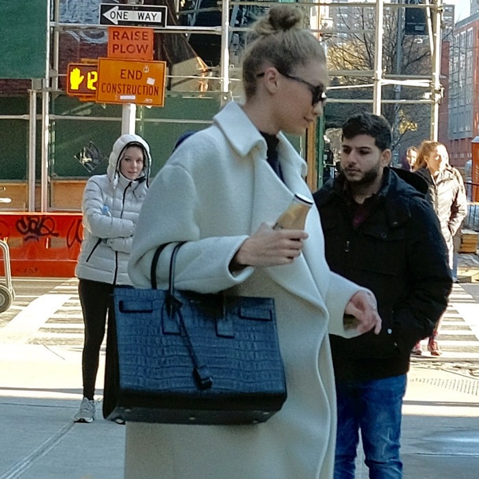 Gigi Hadid leaving her apartment in a winter white overcoat in New York City on January 10, 2018