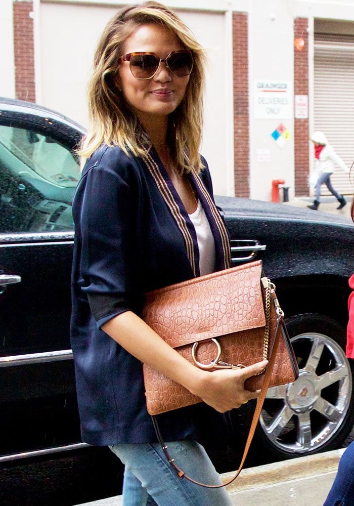 Chrissy Teigen toting her favorite Coach handbag