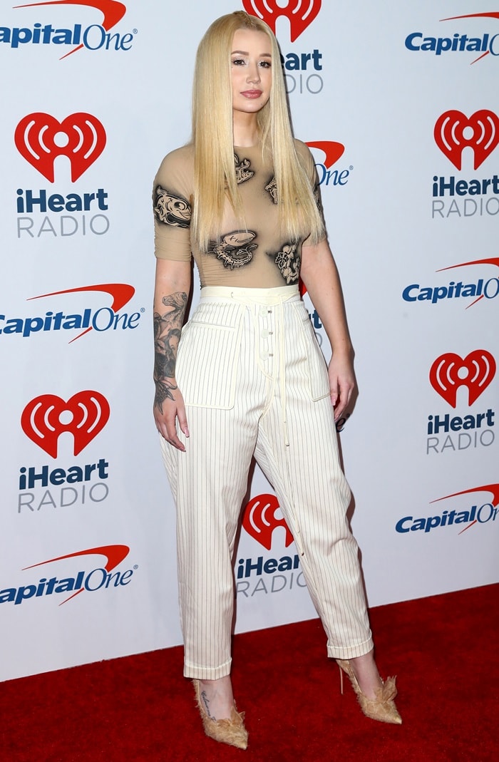 Iggy Azalea rocking quirky white pinstripe pants with Toufrou pumps