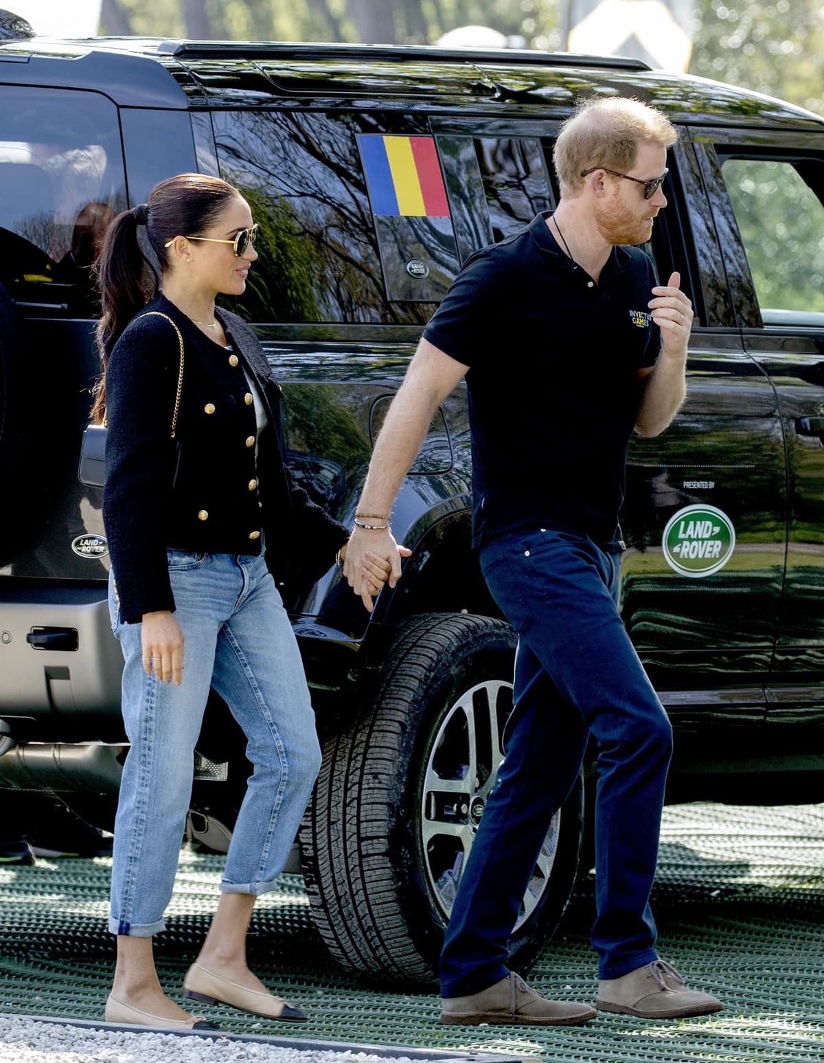 Meghan Markle and Prince Harry hold hands as they arrive for Jaguar Land Rover Driving Challenge