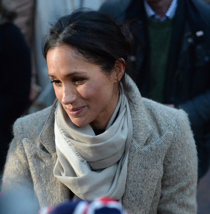 Meghan Markle styled stone-colored coat by Smythe with a scarf from fashion clothing retailer Jigsaw