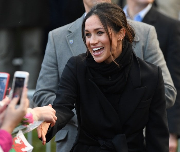 Meghan Markle wore a Stella McCartney tuxedo-inspired wool-blend coat styled with a satin waist tie in a bow