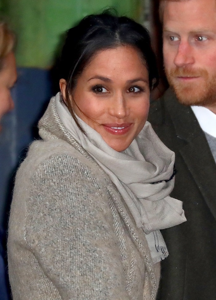 Meghan Markle wearing a beautiful Smythe coat with a multi-wrap scarf