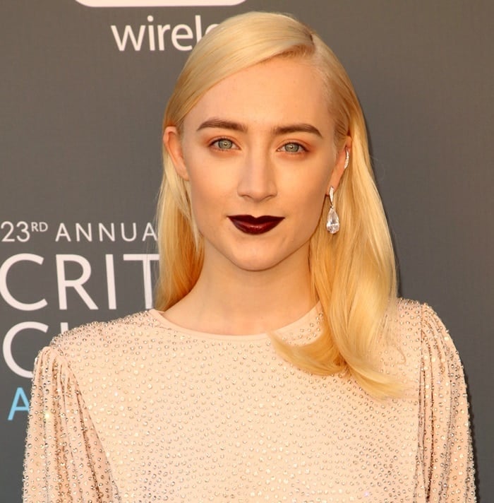 Saoirse Ronan wearing a silver crystal-embroidered gown by Michael Kors featuring a fitted skirt and a loose top at the 2018 Critics’ Choice Awards at The Barker Hangar in Santa Monica, California, on January 11, 2018