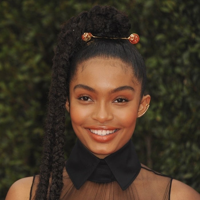 Yara Shahidi makes a bold statement with a high trio-braided ponytail adorned with gold accents