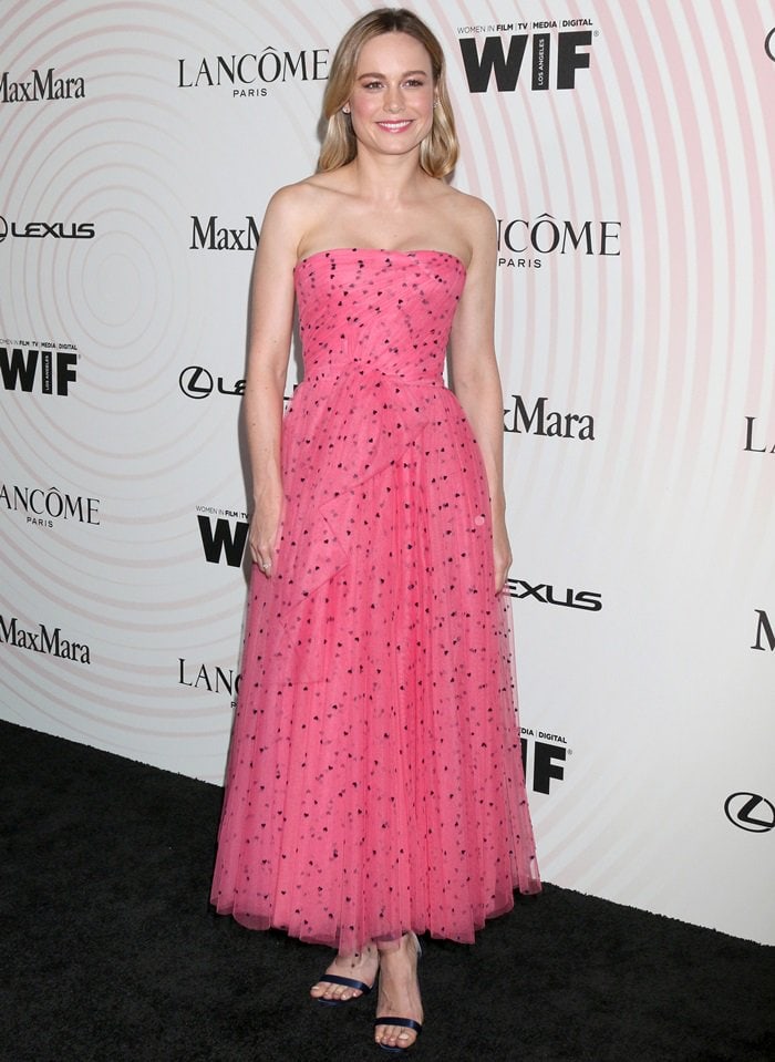 Brie Larson in a pink strapless Carolina Herrera Resort 2019 flamingo tulle dress and transparent Jonatina PVC clear heel strap sandals