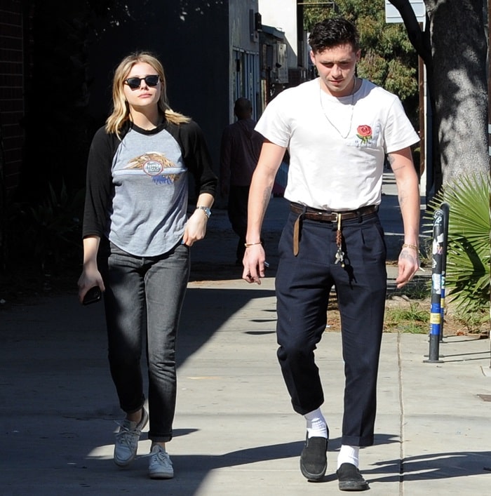 Chloe Moretz styled Citizens of Humanity jeans with Oliver Peoples sunglasses, a Doobie Brothers tee, and white sneakers from Reebok