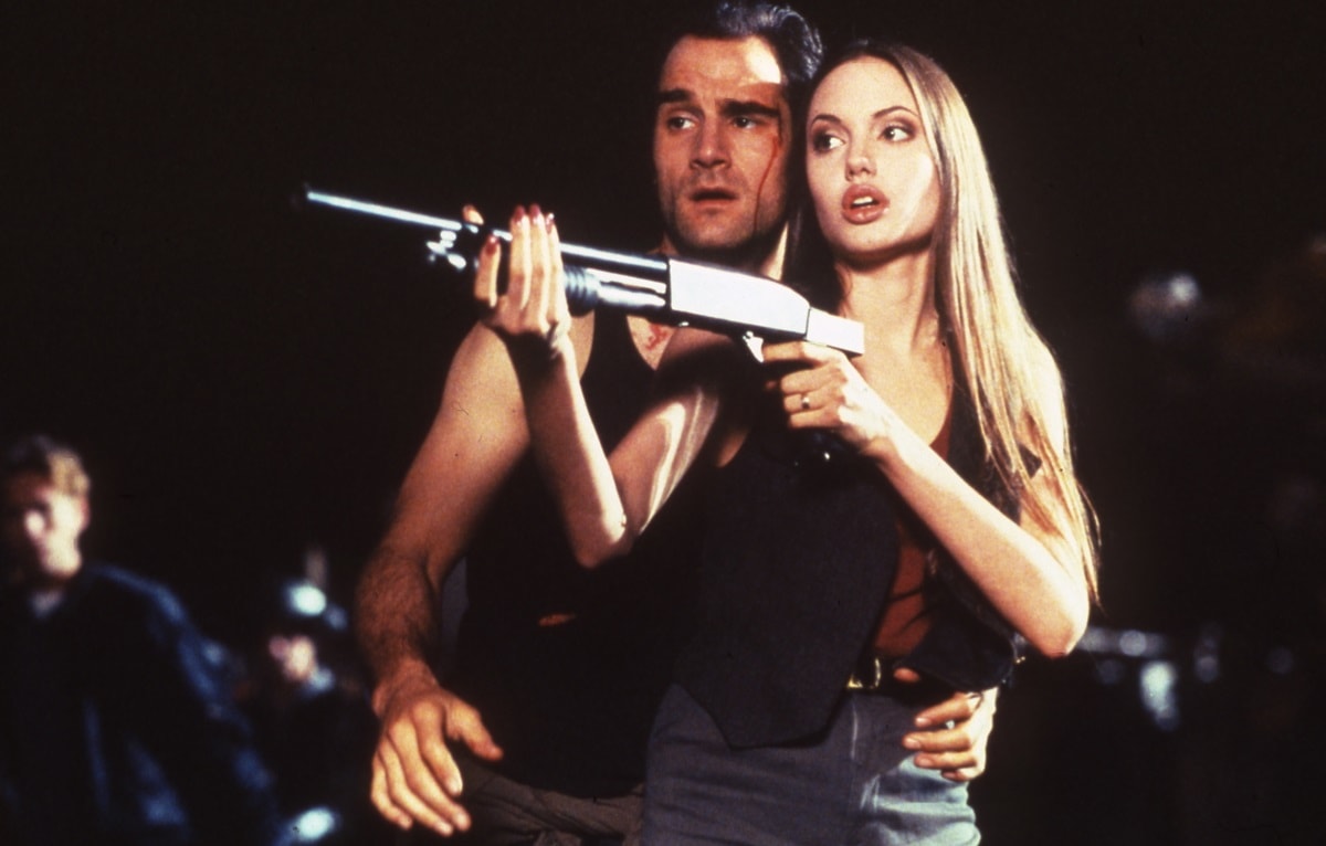 Elias Koteas as Colton "Colt 45" Ricks and Angelina Jolie as Casella "Cash" Reese in the 1993 American science fiction action film Cyborg 2 (released in some countries as Glass Shadow)