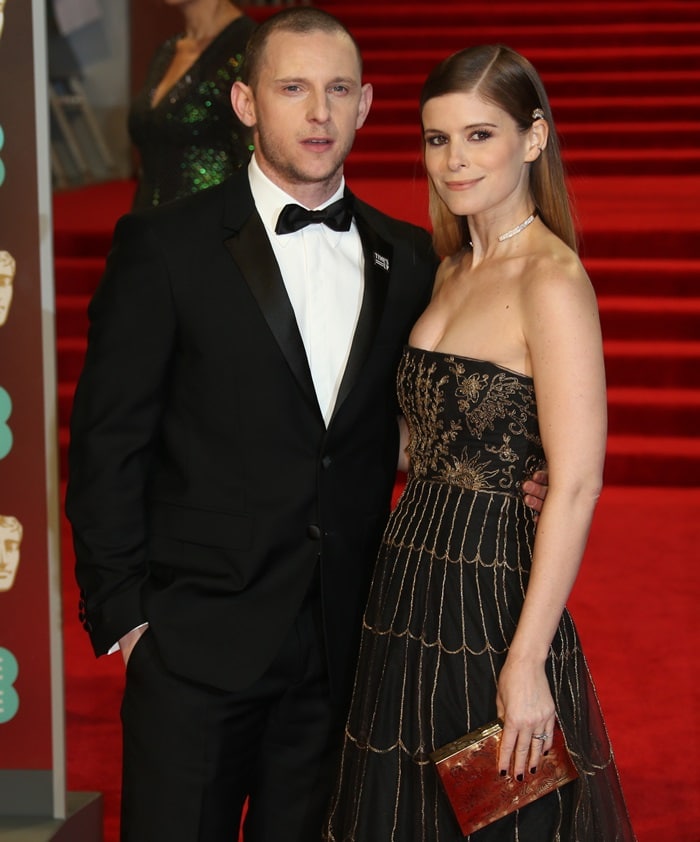 Kate Mara stuns in an embroidered strapless gown with sleek straight hair tucked behind her ears, while Jamie Bell looks dapper in a classic black tuxedo at the 2018 BAFTAs