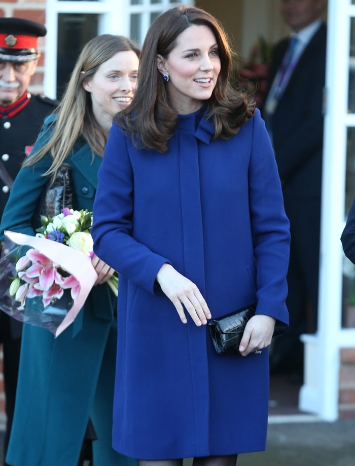 Catherine, Duchess Of Cambridge (aka Kate Middleton) wearing a marine blue Goat coat while greeting visitors at the opening of the Action On Addiction Community Treatment Centre in Wickford, England, on February 7, 2018