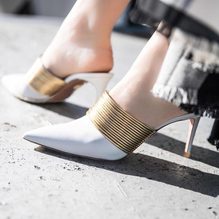 These mules are detailed with the same fine metallic strips as those seen on the label's coveted 'Spin Me Around' sandals