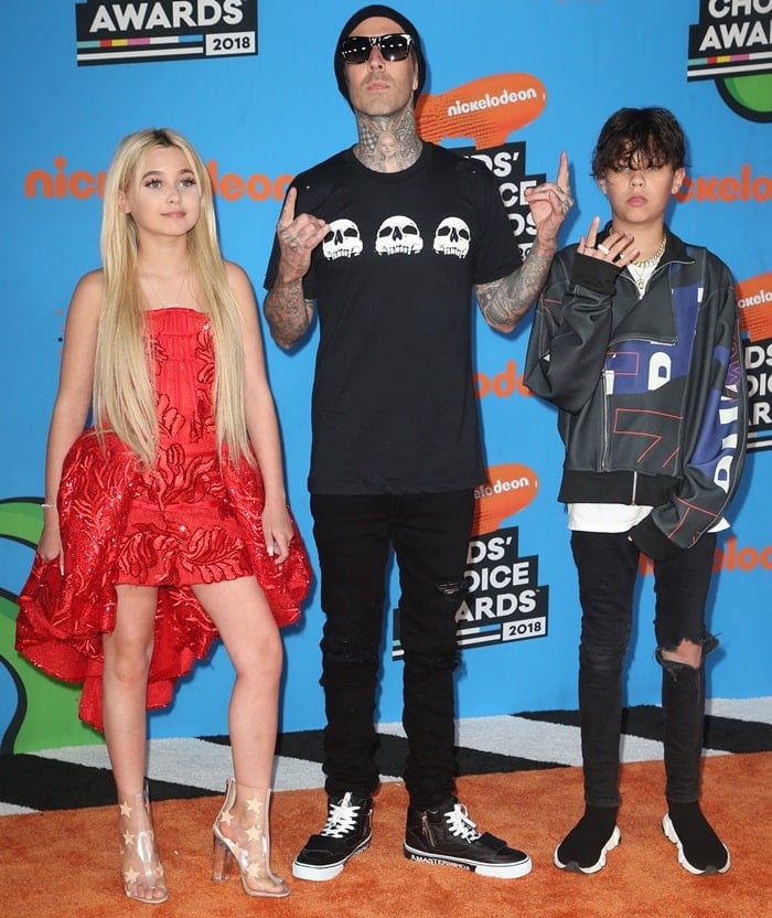 Alabama Barker stuns in a bold red dress and star-studded PVC heels alongside her father, Travis Barker, and brother, Landon Barker