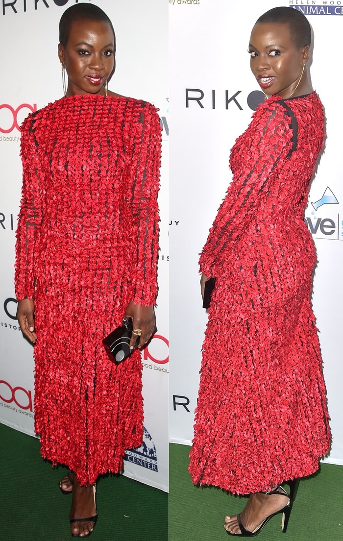 Danai Gurira stuns in a vibrant red Christopher Kane midi dress paired with sleek black stiletto sandals