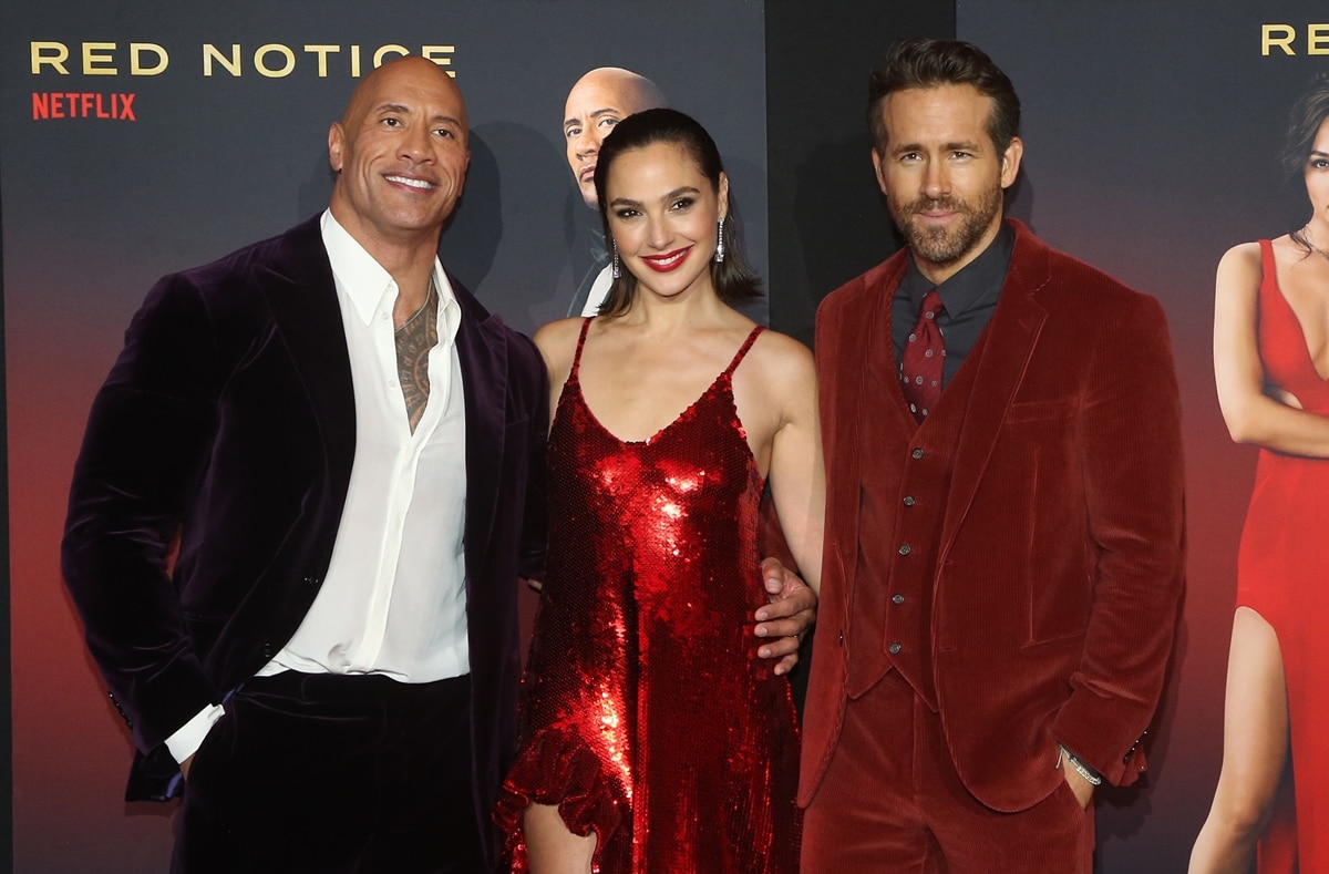 Dwayne Johnson, Gal Gadot, and Ryan Reynolds thinking about their paychecks at the premiere of their new movie Red Notice
