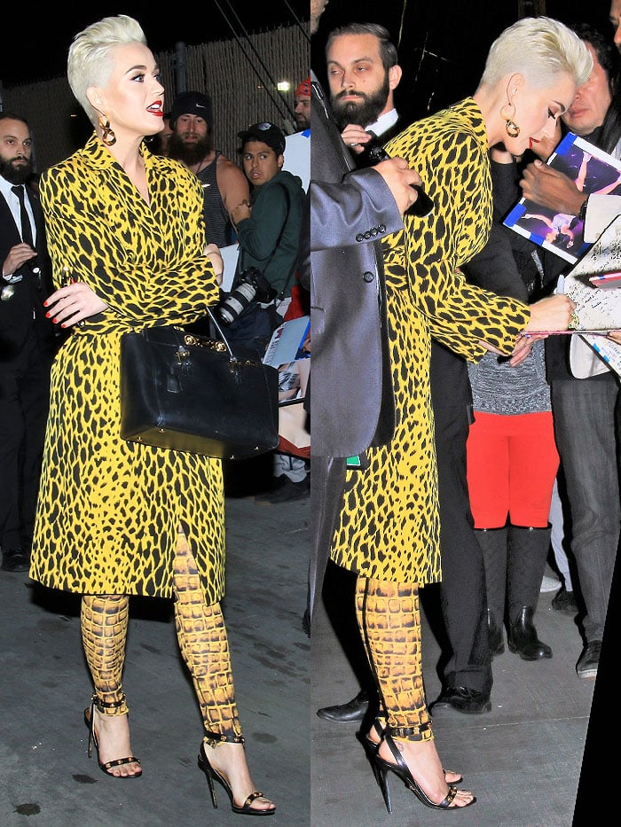 Katy Perry signing autographs in a yellow, animal-print outfit and Versace medallion ankle-strap sandals.