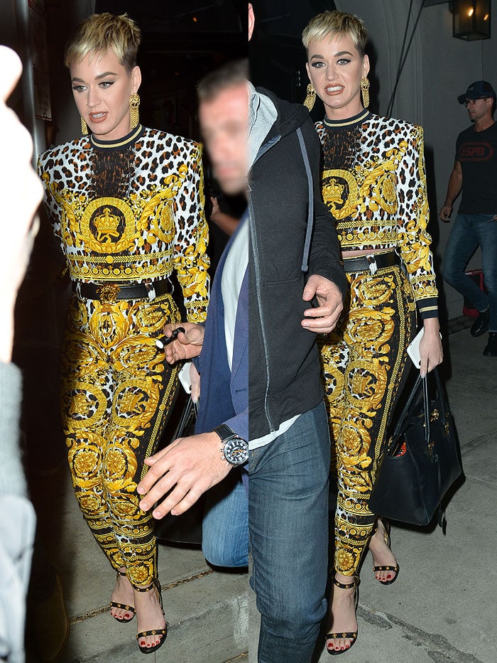 Katy Perry wearing a Versace yellow animal-print ensemble with Versace ankle-strap sandals at Craig’s Restaurant.