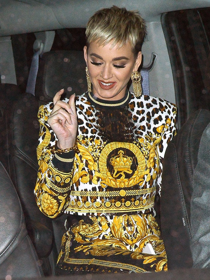 Katy Perry wearing Versace top and pants coordinates with leopard and gold scrollwork prints.