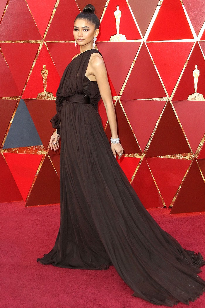 Zendaya exudes elegance in a Giambattista Valli Spring 2018 Couture brown one-sleeve gown and Brian Atwood 'Karin' platform sandals at the Oscars