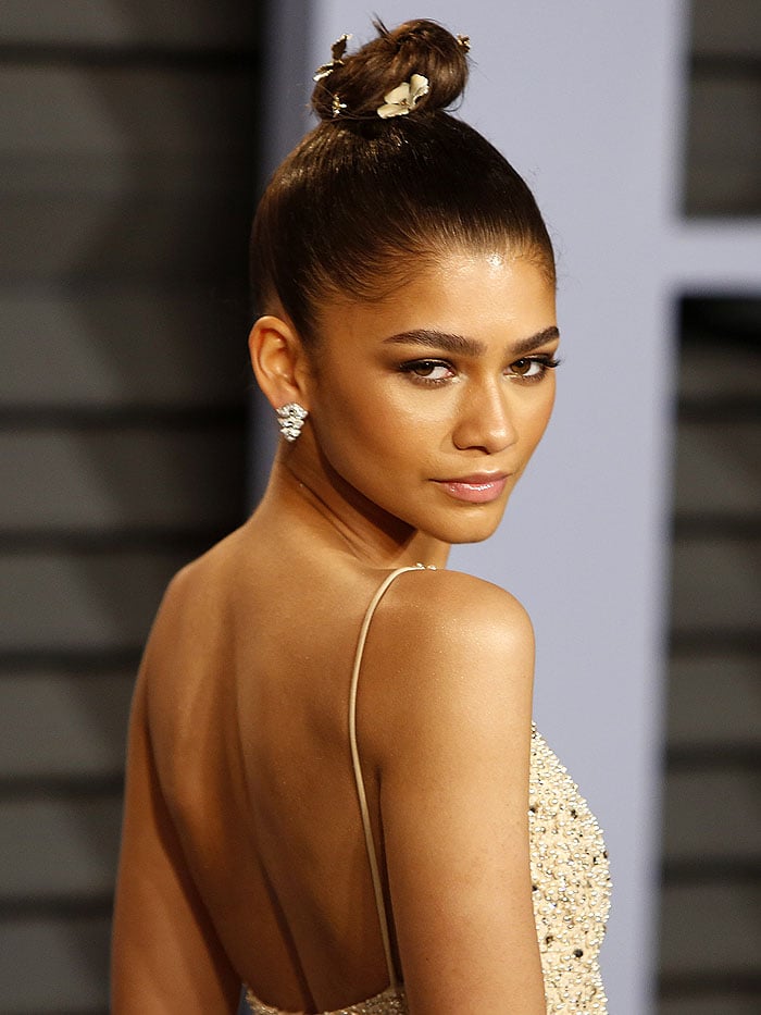 Zendaya sparkles with Jennifer Behr 'Juliette' gold flower bobby pins in her top knot at the Vanity Fair Oscar Party
