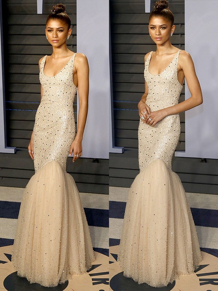 Zendaya wearing a custom Michael Kors beaded mermaid gown and Jennifer Behr gold flower hair pins at the 2018 Vanity Fair Oscar Party.