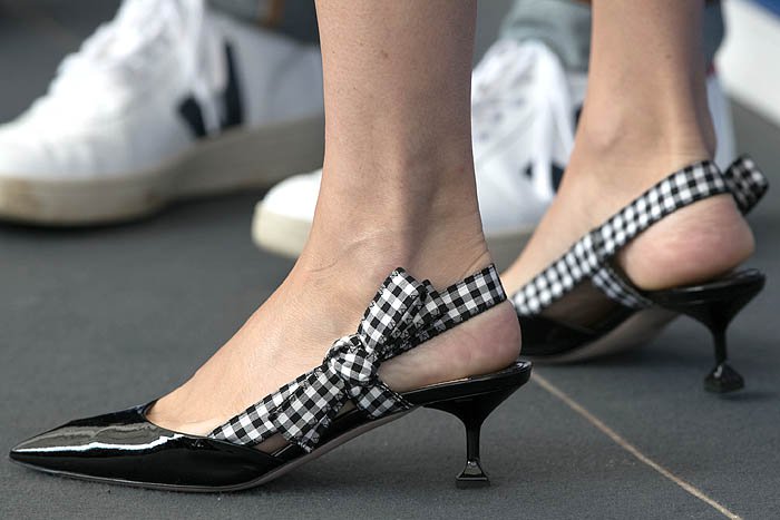 Details of the Miu Miu gingham-ribbon patent slingback pumps on Chloë Sevigny.