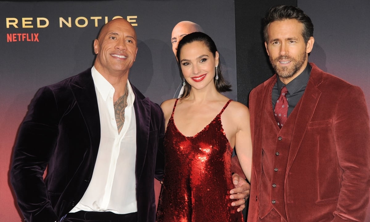 Dwayne Johnson is comfortably taller than Gal Gadot but seems to be a little shorter than Ryan Reynolds