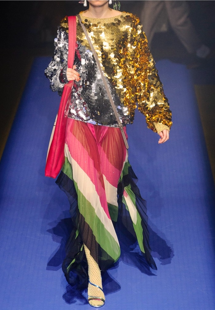 Model wearing the 'Haines' braided metallic leather sandals on the Gucci runway