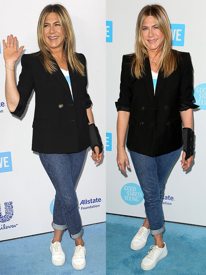 Jennifer Aniston keeps it effortlessly chic at WE Day California, pairing a black Givenchy blazer with cuffed jeans and white sneakers